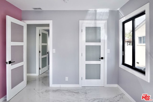 unfurnished bedroom featuring french doors