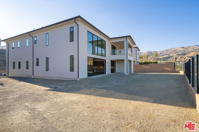 rear view of house featuring a mountain view