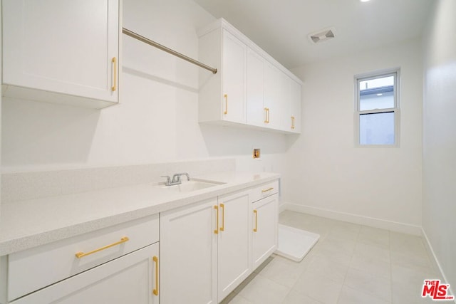 laundry area with cabinets, sink, and washer hookup