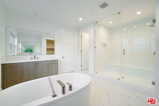 bathroom with shower with separate bathtub and vanity