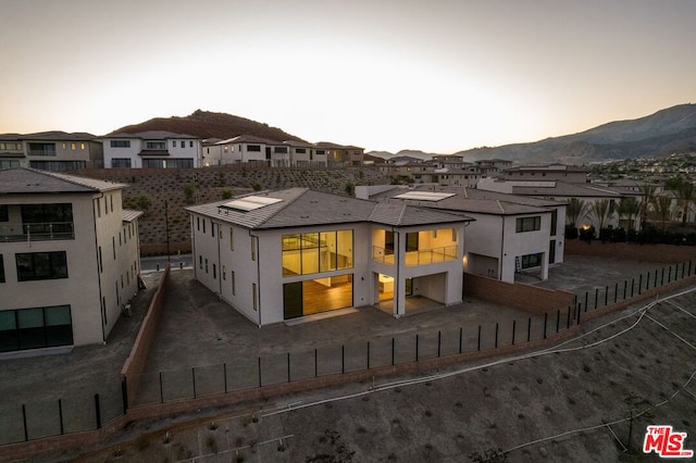 back house at dusk with a mountain view