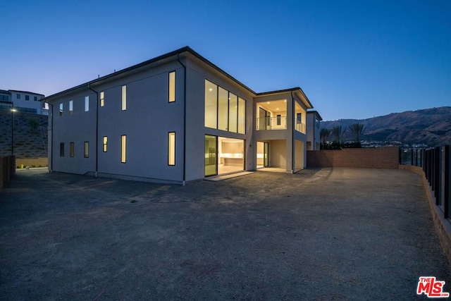 back house at dusk with a mountain view