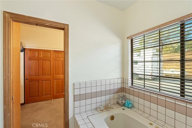 bathroom with a relaxing tiled tub