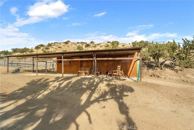 view of stable featuring a rural view