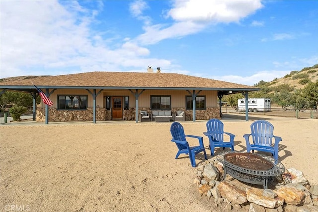 6535 Juniper Crest Rd, Agua Dulce, CA 91390 - rear view of house featuring a fire pit, stone siding, a chimney, a patio, and a shingled roof