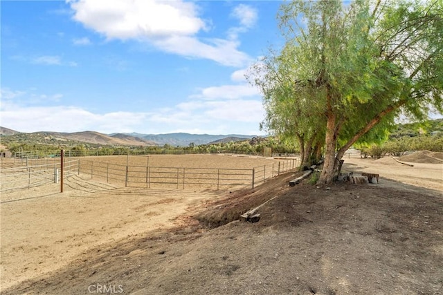 view of yard with a mountain view and a rural view