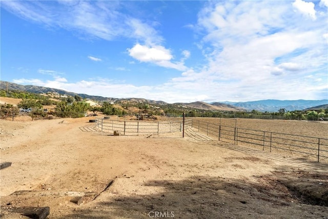 view of yard featuring a mountain view and a rural view