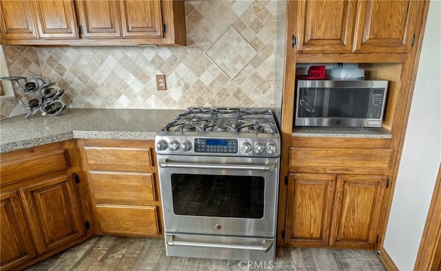 6535 Juniper Crest Rd, Agua Dulce, CA 91390 - kitchen featuring appliances with stainless steel finishes, brown cabinets, and tasteful backsplash