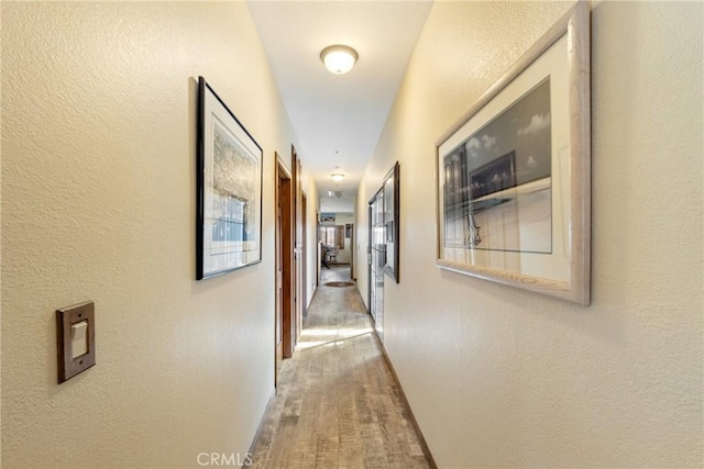 corridor with wood-type flooring