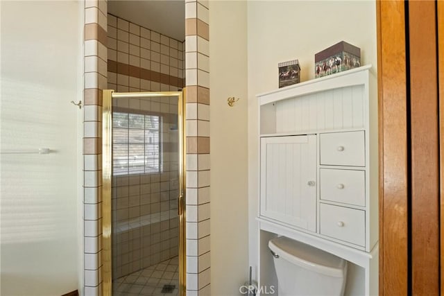 bathroom featuring toilet and walk in shower