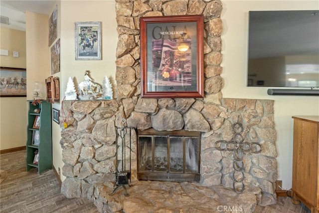 room details with a fireplace and wood-type flooring