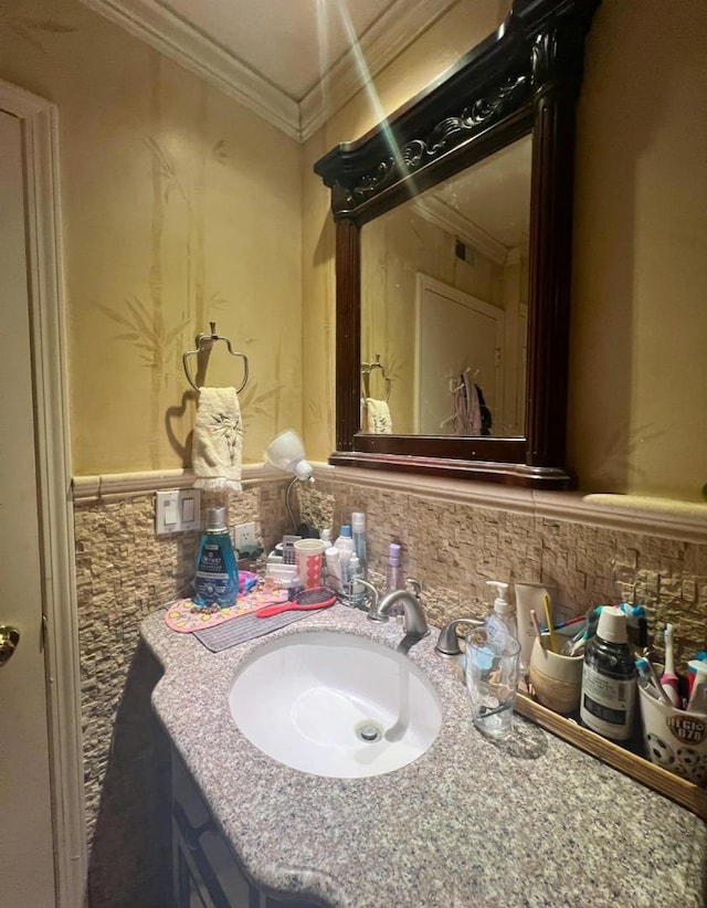 bathroom with crown molding and vanity