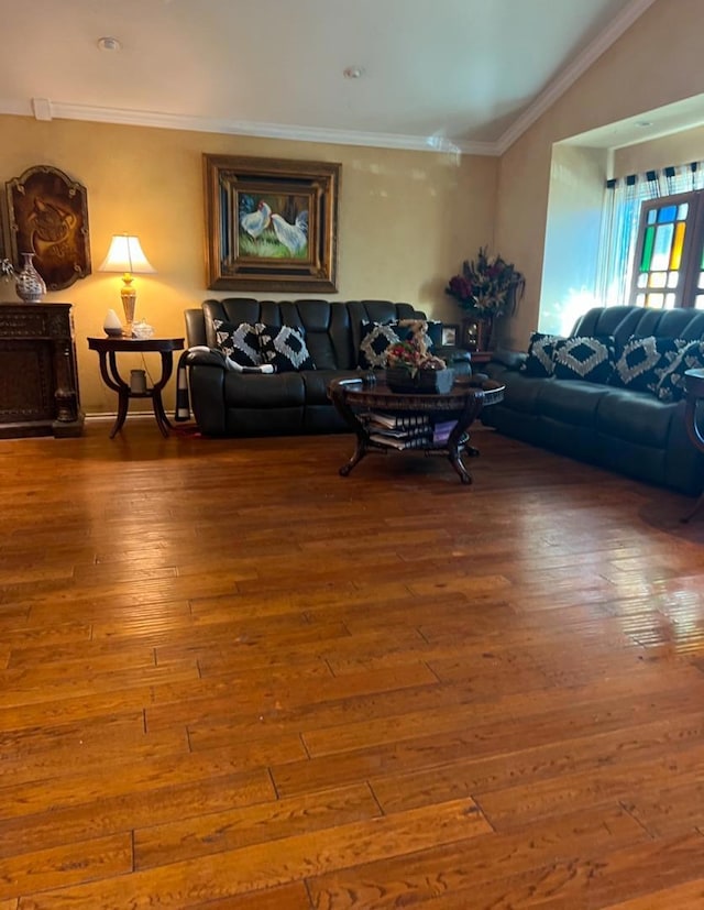 living room featuring ornamental molding, vaulted ceiling, and hardwood / wood-style floors