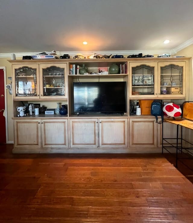 unfurnished living room with dark hardwood / wood-style flooring and crown molding