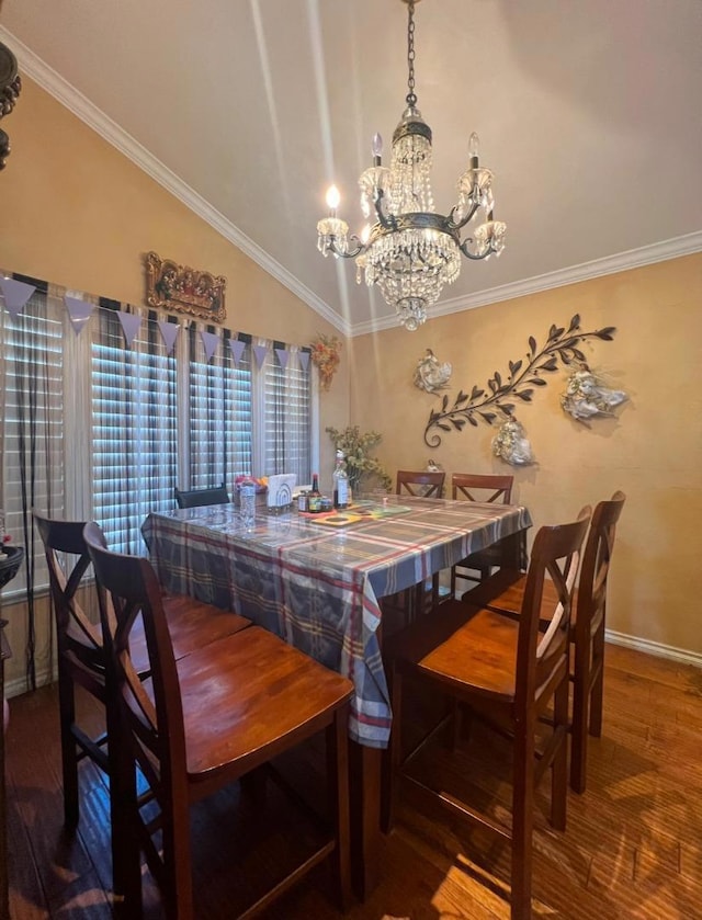 dining space with dark wood-type flooring, crown molding, vaulted ceiling, and a notable chandelier