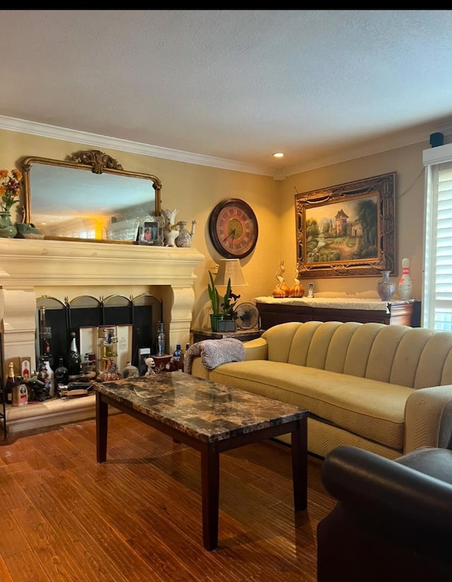 living room featuring hardwood / wood-style flooring, indoor bar, and crown molding