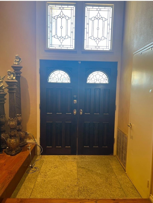 foyer entrance featuring a high ceiling