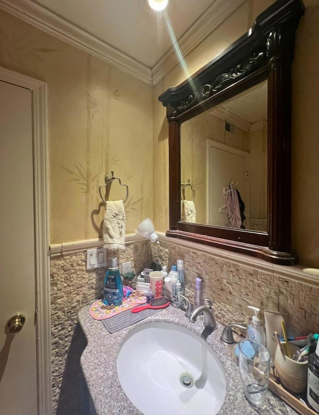 bathroom featuring ornamental molding and vanity