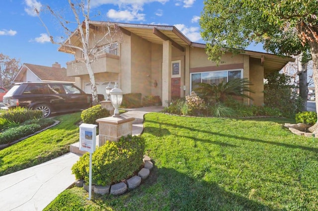 view of front of home with a garage, a balcony, and a front lawn