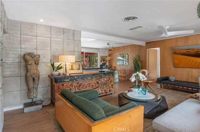 living room featuring ceiling fan and hardwood / wood-style floors