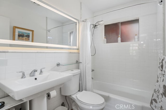 bathroom with tasteful backsplash, shower / bath combo with shower curtain, tile walls, and toilet