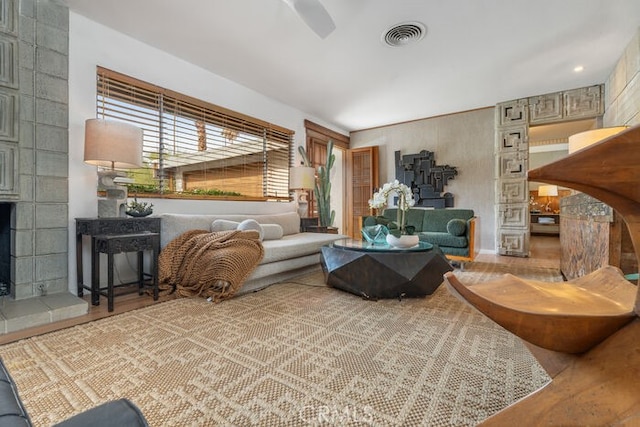 living room featuring a tile fireplace