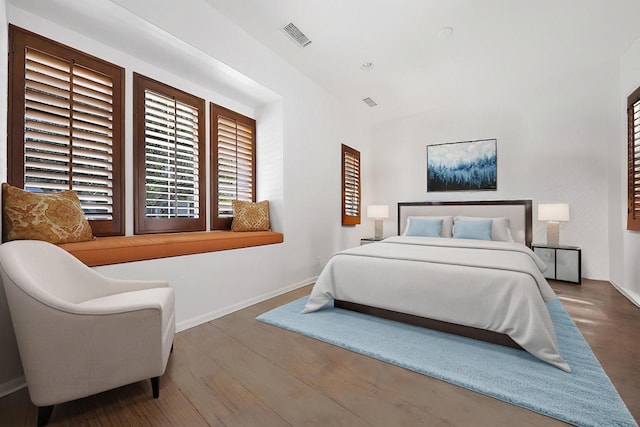 bedroom with dark wood-type flooring