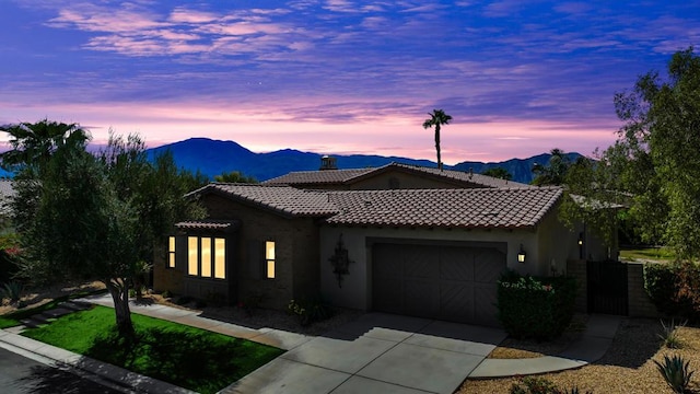 view of front of home with a mountain view and a garage