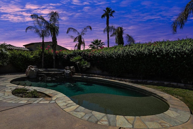 view of pool at dusk