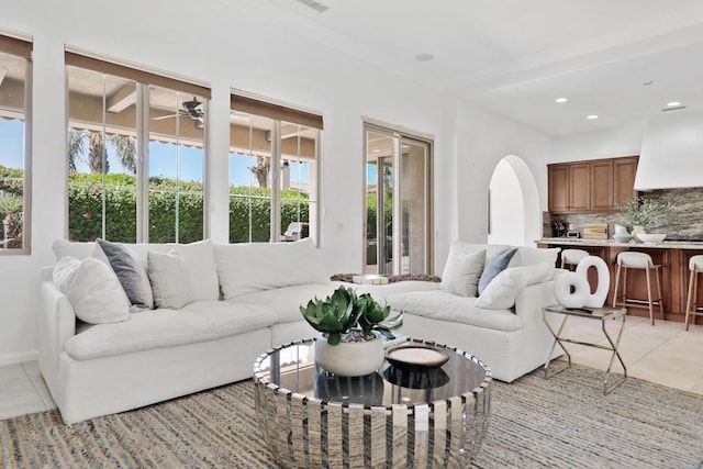 tiled living room featuring a healthy amount of sunlight