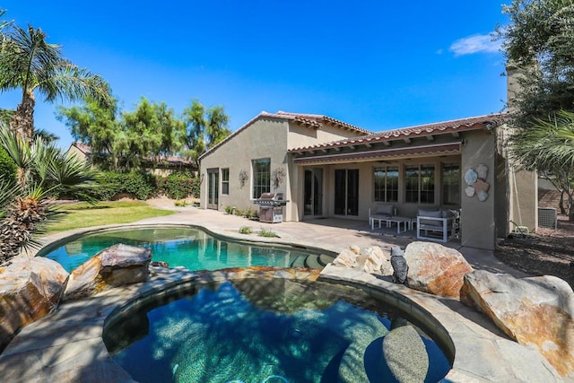 view of pool featuring a patio area and grilling area