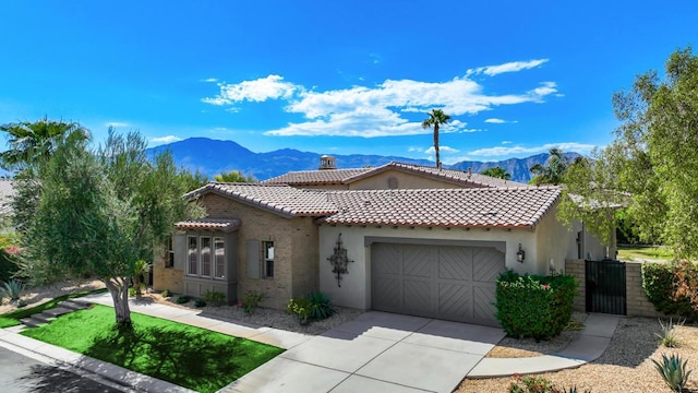 mediterranean / spanish house with a mountain view and a garage