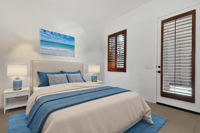 bedroom with light hardwood / wood-style floors and access to outside