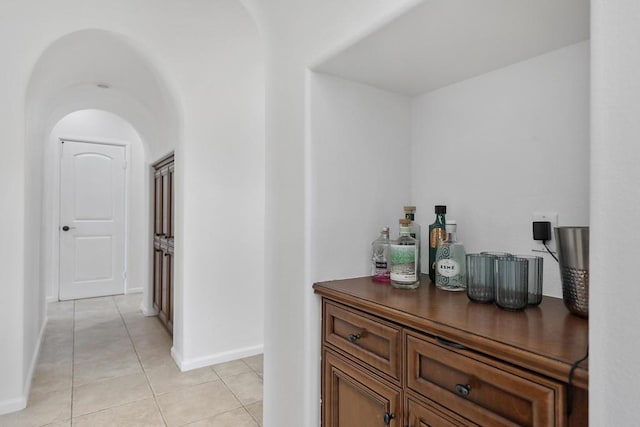 corridor with light tile patterned flooring