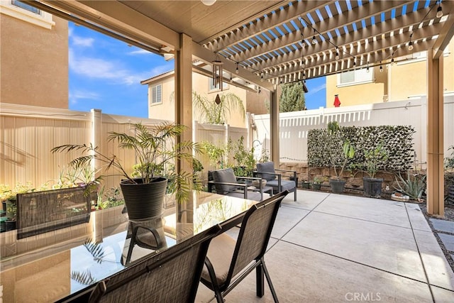 view of patio / terrace with outdoor dining area, a fenced backyard, and a pergola