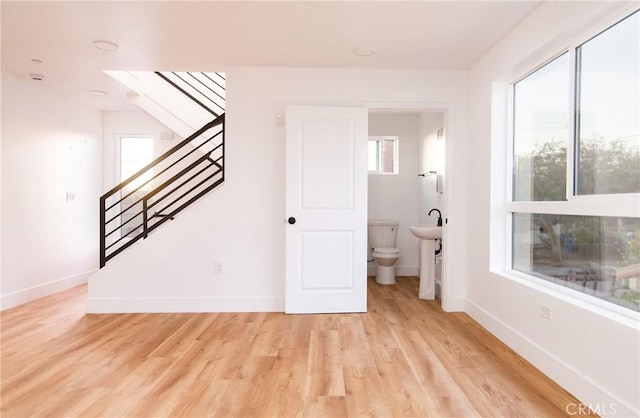 interior space featuring light hardwood / wood-style flooring, a healthy amount of sunlight, and sink