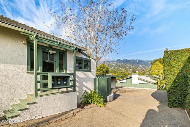 view of side of property with a mountain view