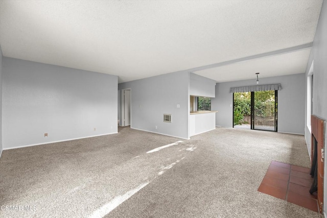 unfurnished living room with a textured ceiling and carpet flooring