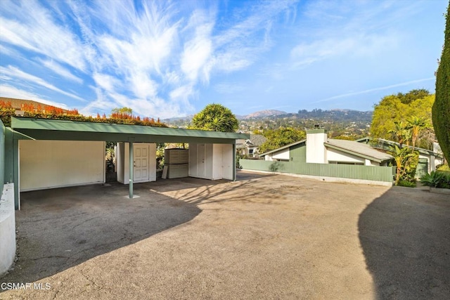 garage with a carport and a mountain view