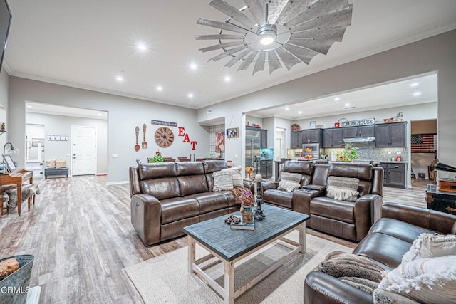 living room featuring ornamental molding and light hardwood / wood-style floors