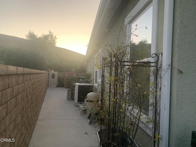 property exterior at dusk with a mountain view