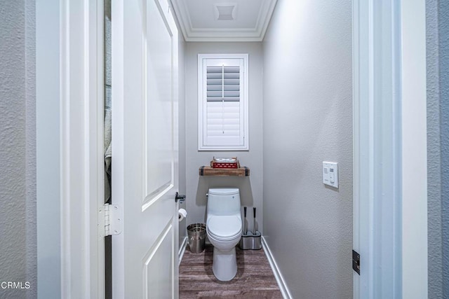 bathroom with ornamental molding, wood-type flooring, and toilet