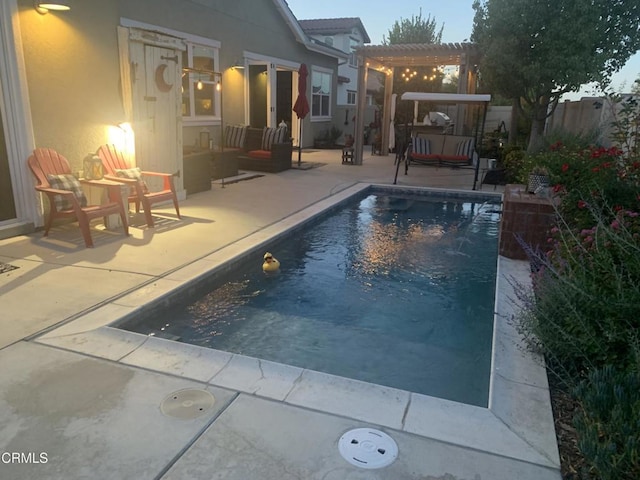 view of swimming pool with a patio and a pergola