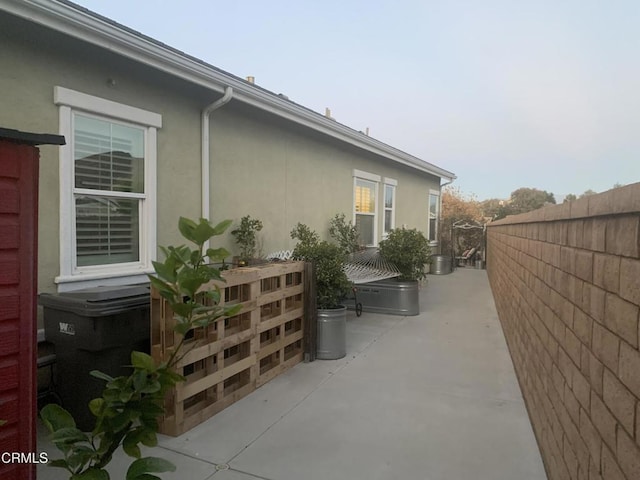 view of property exterior with a patio area