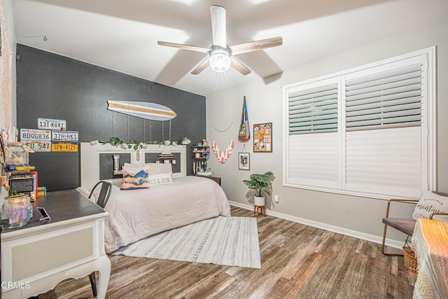 bedroom featuring wood-type flooring and ceiling fan