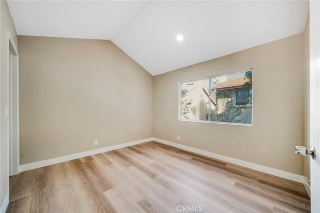 empty room featuring light hardwood / wood-style flooring and lofted ceiling