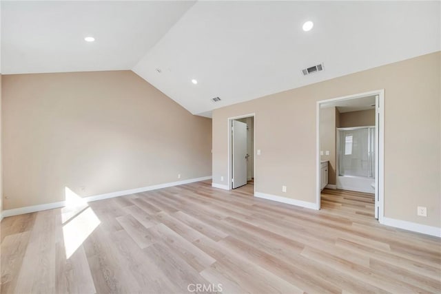 interior space with lofted ceiling and light wood-type flooring