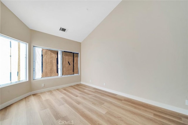 empty room featuring light hardwood / wood-style floors and lofted ceiling