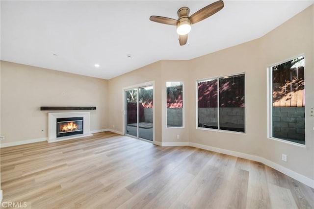 unfurnished living room with ceiling fan and light hardwood / wood-style flooring