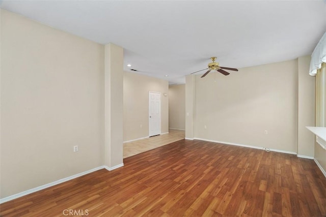 empty room with ceiling fan and hardwood / wood-style flooring